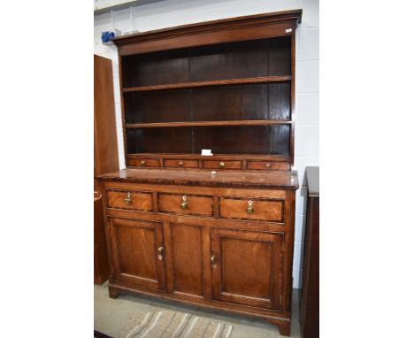 An 19th Century part oak and cross banded dresser , plate racking having three drawers to base, over triple frieze drawer and