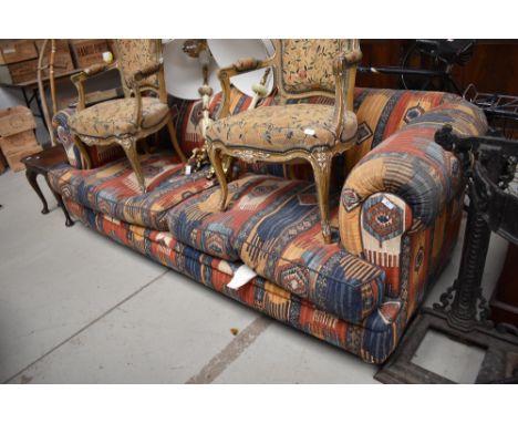 A modern settee, having traditional Eastern tapestry rug upholstery