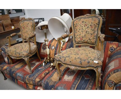 A pair of C19th gilt wood armchairs, in the French style, having tapestry upholstery