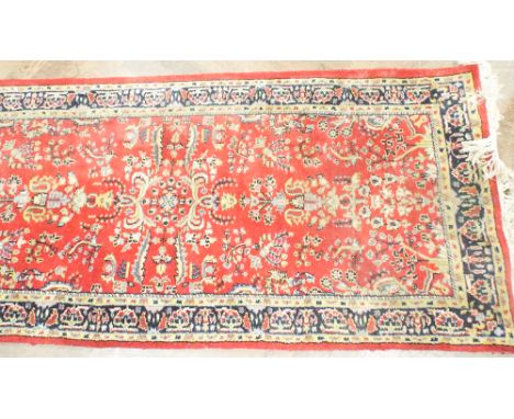 Indian wool carpet runner with red ground 