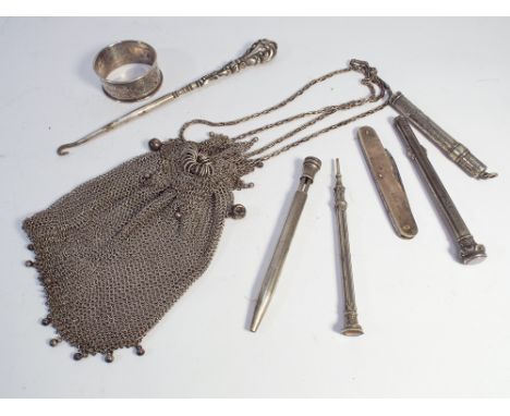 A collection of small silver items to include pen knife, propelling pencil, silver handled button hook, white metal mesh even