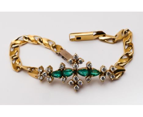 An 18ct yellow gold emerald and diamond bracelet set with a central panel of brilliant cut diamonds and Marquise shaped emera