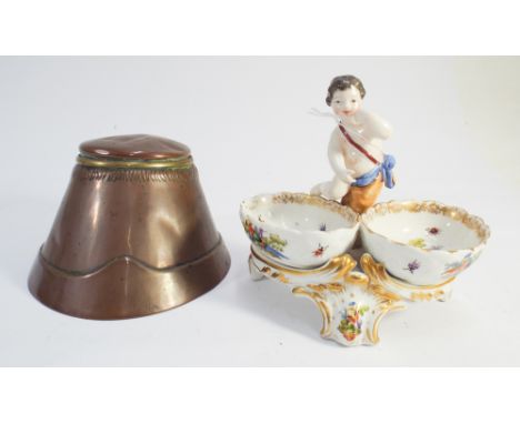 A Berlin porcelain table salt cellar with cherub figure to the centre(chipped) together with a novelty copper horses hoof ink