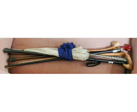 5 walking sticks,a collectable white metal handled parasol, one walking stick with silver collar etc. 
