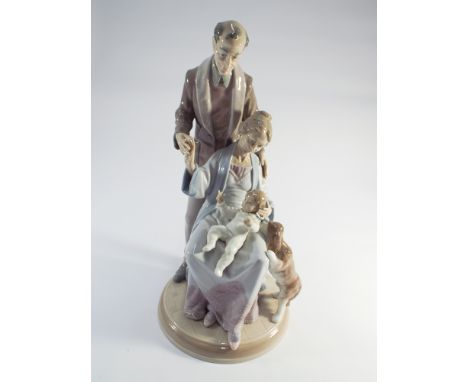 A large Lladro figure group of Grandparents with a baby on a circular pedestal base 35cms tall  no obvious sign of damage or 