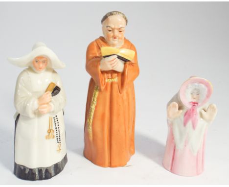Three Royal Worcester candle snuffers, a Nun, a Friar and an Old Lady