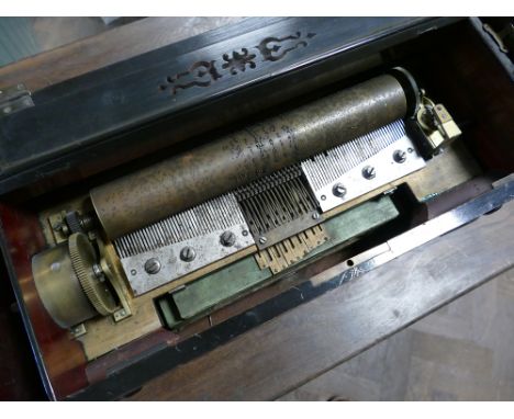 19th century Swiss musical box playing 6 airs numbered 893036173 in a figured walnut case.  13" cylinder.  In un-restored con