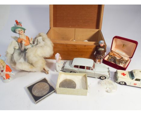 Collectable to include porcelain pin cushion half dolls, old Lesney toys, crowns, silver plated commemorative spoons etc 