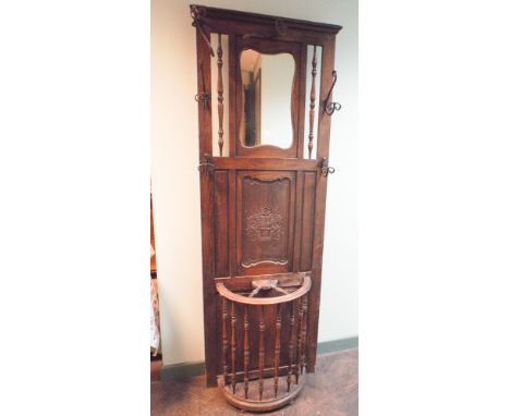 Early 20th century French carved oak hallstand with mirror back panel, coat hooks and a cartwheel design stick stand under 