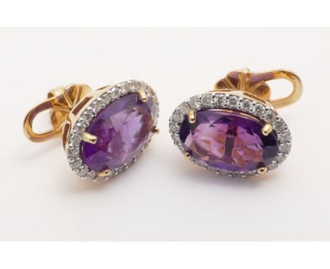 Pair of 18ct yellow gold amethyst and diamond earrings with pierced fittings set with large oval amethysts weighing 8.5cts su