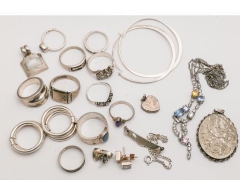 A collection of silver jewellery to include earring dress rings oval locket etc