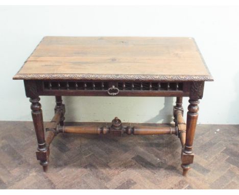 Late 19th century carved French oak side table with one fitted deep drawer with bobbin turned details and stretcher base.  To