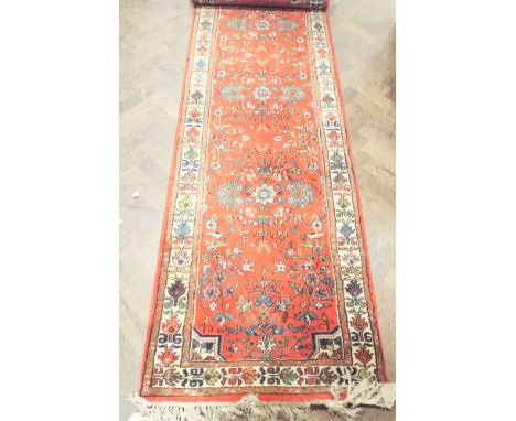 Indian carpet runner with red ground - approx 122" long x 30.5" wide 