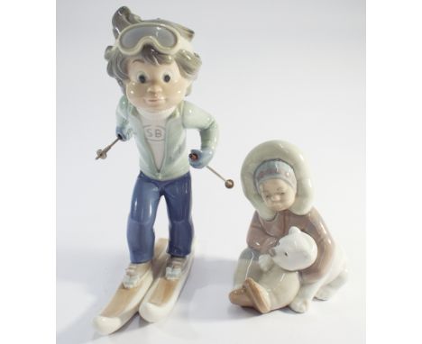 2 Lladro porcelain figurines Eskimo child hugging a polar bear cub and a skier 