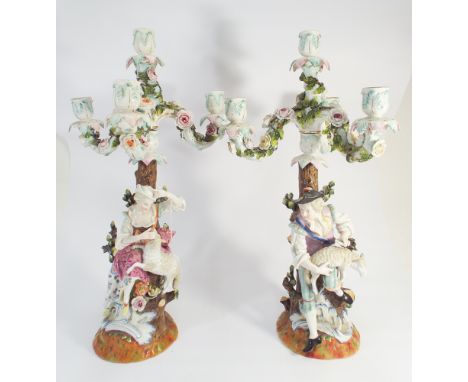 A pair of Dresden Augustus Rex figural candelabra each candlestick with three branches and central candle holder with fixed s