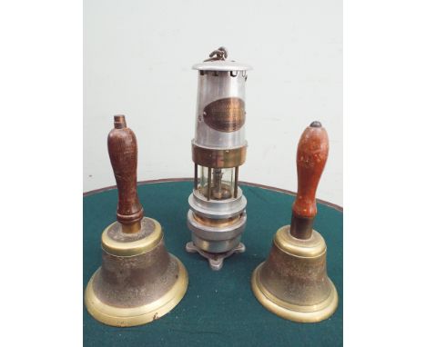 2 brass hand bells and a miners safety lamp 
