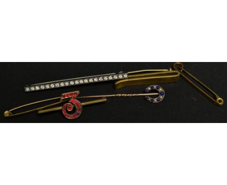 A seed pearl and blue cabochon inset horseshoe stick pin, unmarked mount and spiralled shaft;  a 9ct gold and gold plated No 