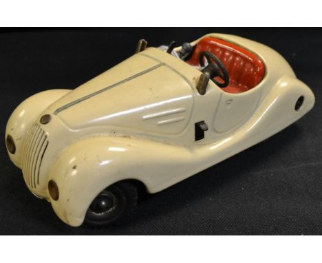 Schuco (Germany) a Pre-War Examico 4001 Clockwork Tinplate Car, cream body, red seats, tin-printing detail dashboard, missing