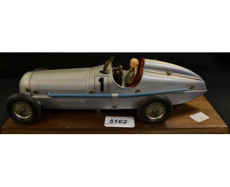 A Marklin Silver Arrow Clockwork Racing Car, silver body, blue exhaust, red interior, cream driver, silvered hubs, Rn 1, with