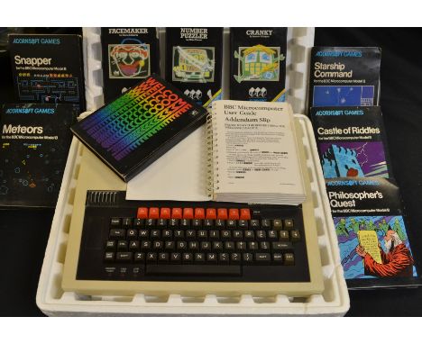 A BBC Microcomputer system, with welcome pack and user manual, designed by Acorn Computers Ltd with boxed games, Facemaker, N