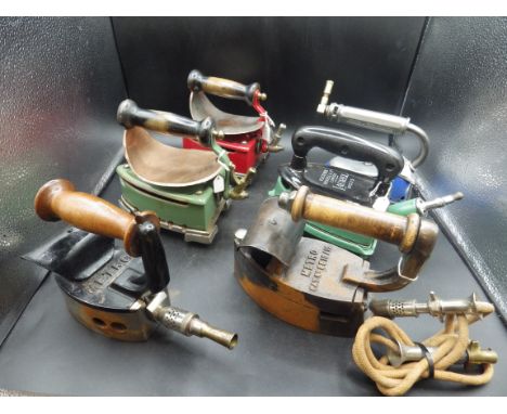 3 Fletcher Russel &amp; Co enamel 'Laurel' gas irons, all with trivets and 2 with heat shields together with 3 Metro gas iron
