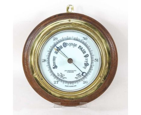 An early 20th century brass cased ship's barometer, signed John Barker &amp; Co. Ltd, Kensington, mounted on a wooden base, 2