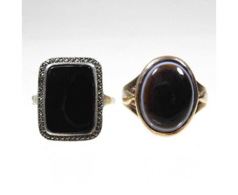 A 9 carat gold polished onyx cabochon ring, 6.2g, size N, together with a black onyx dress ring, size N, boxed (2)