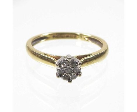 An 18 carat gold diamond set cluster ring, set with seven stones, 2.9g, size N
