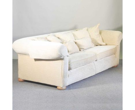 A large cream upholstered Multiyork chesterfield sofa, with loose cushions238w x 113d x 76h cm