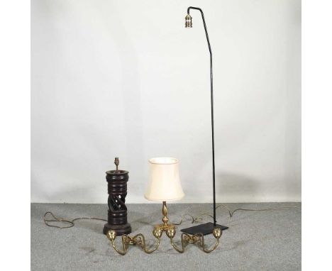 A modern standard lamp, 166cm high, together with carved table lamps and two brass wall sconces (5)