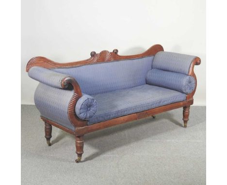 A William IV carved mahogany scroll end sofa, upholstered in blue, with scrolled arms, on turned feet, terminating in brass c