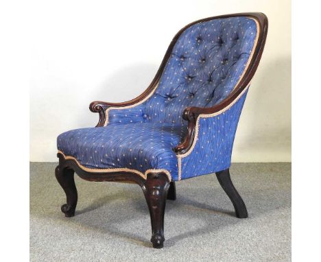 A Victorian carved rosewood and blue upholstered button back armchair, on cabriole legs