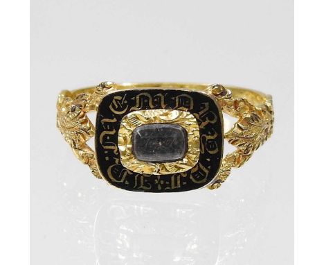 A Victorian enamelled mourning ring, inset with plaited hair, within a scrolled surround, inscribed John Edmeades, ob 17 Sept