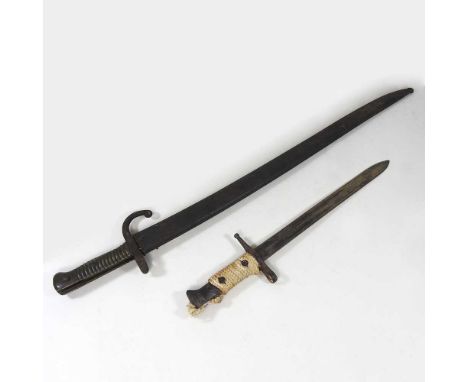 A late 19th century French bayonet, in a metal scabbard, 72cm long, together with another smaller (2)Larger bayonet was stuck