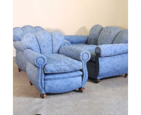 An early 20th century blue upholstered three piece suite, comprising a pair of armchairs and a sofa (3)158w x 80d x 82h cmOve