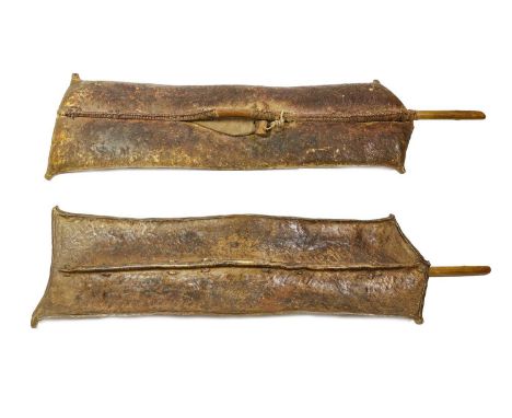 A Turkana Hide Shield, Kenya, of elongated rectangular form with incised and rolled edge, raised medial ridge, the reverse wi