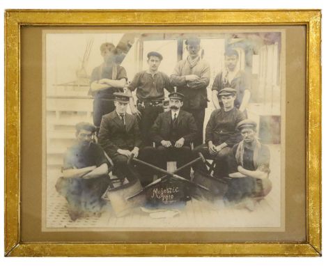 The White Star Line Ship Majestic - a Real Photographic Group Portrait, depicting engine room crew and firemen seated and sta