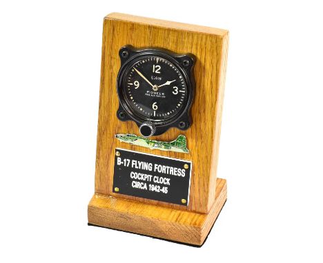 A Second World War B-17 Flying Fortress Cockpit Clock, the circular black enamel dial with luminous arabic quarter numerals e