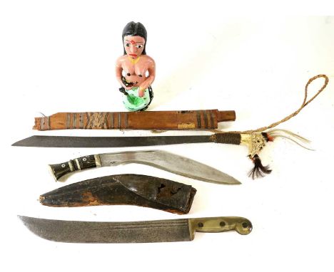 A Dyak Borneo Mandau (Head Hunter's Sword), with 47cm steel blade, bone hilt carved with mythical beasts and set with tufts o