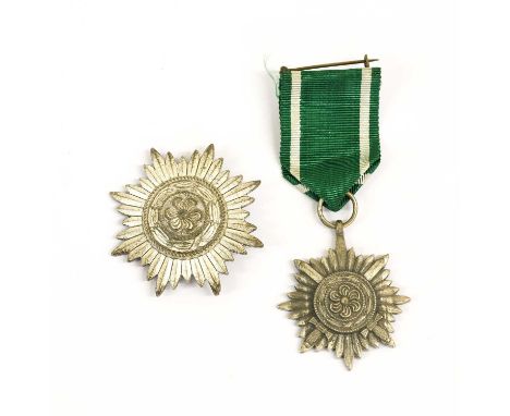 An Ostvolk Decoration for Merit on the Eastern Front,1st Class, in silver, with sword shape pin; an Ostvolk Decoration for Br