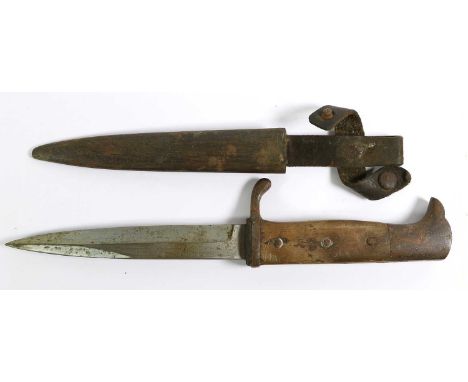 A First World War German Trench Knife, the 15cm single edge steel blade double edged for the last 6cm, the steel crossguard w