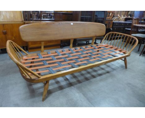 An Ercol elm and beech 355 model studio couch 