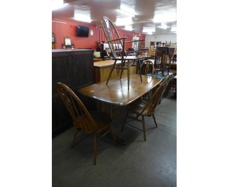 An Ercol Golden Dawn elm and beech refectory table and four chairs 