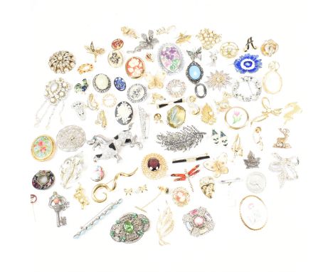 A collection of costume brooches and stick pins. The brooches to include&nbsp;a Miracle mottled stone brooch and silver tone 