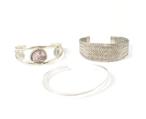 A collection of 925 silver and white metal bangles. The collection to include a 925 silver bangle, stamped 925 and G.E. An al