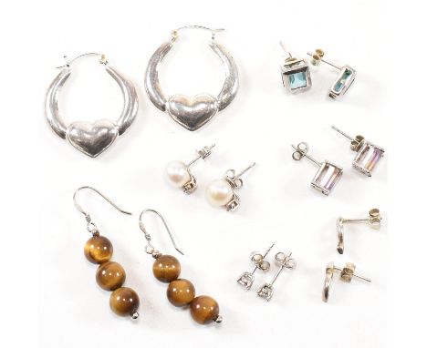 A collection of silver earrings. The earrings to include a pair of silver and tiger's eye French hook earrings, stamped 925. 