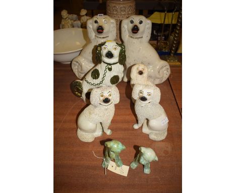 A pair and four other Staffordshire ware spaniel ornaments, various sizes; and two modern ceramic figures of comical puppies.