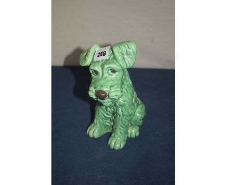 A Sylvac ceramic ornament modelled as a seated comical terrier in green glaze, shape no. 1379.