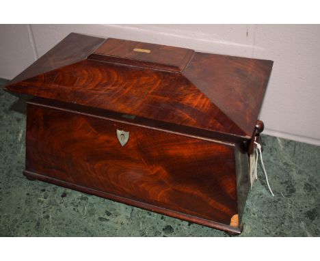 A 19th Century mahogany sarcophagus-shaped tea caddy, with mixing bowl and two interior caddies.