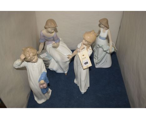 Four Nao ware figures, two modelled as boy and a girl in nightgowns; and two modelled as young girls, one is seated.